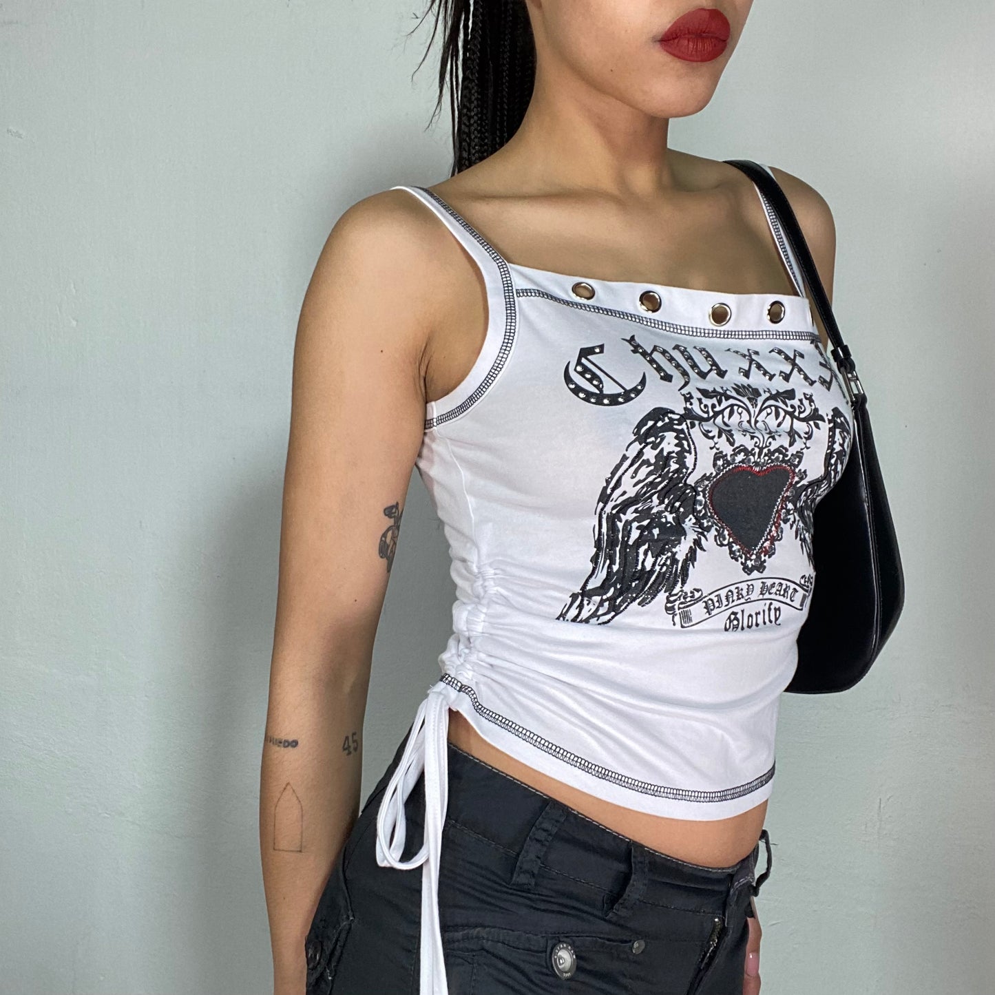 Vintage 2000's Gothic White Top with Winged Heart Print and Metal Eyelet Details (S)